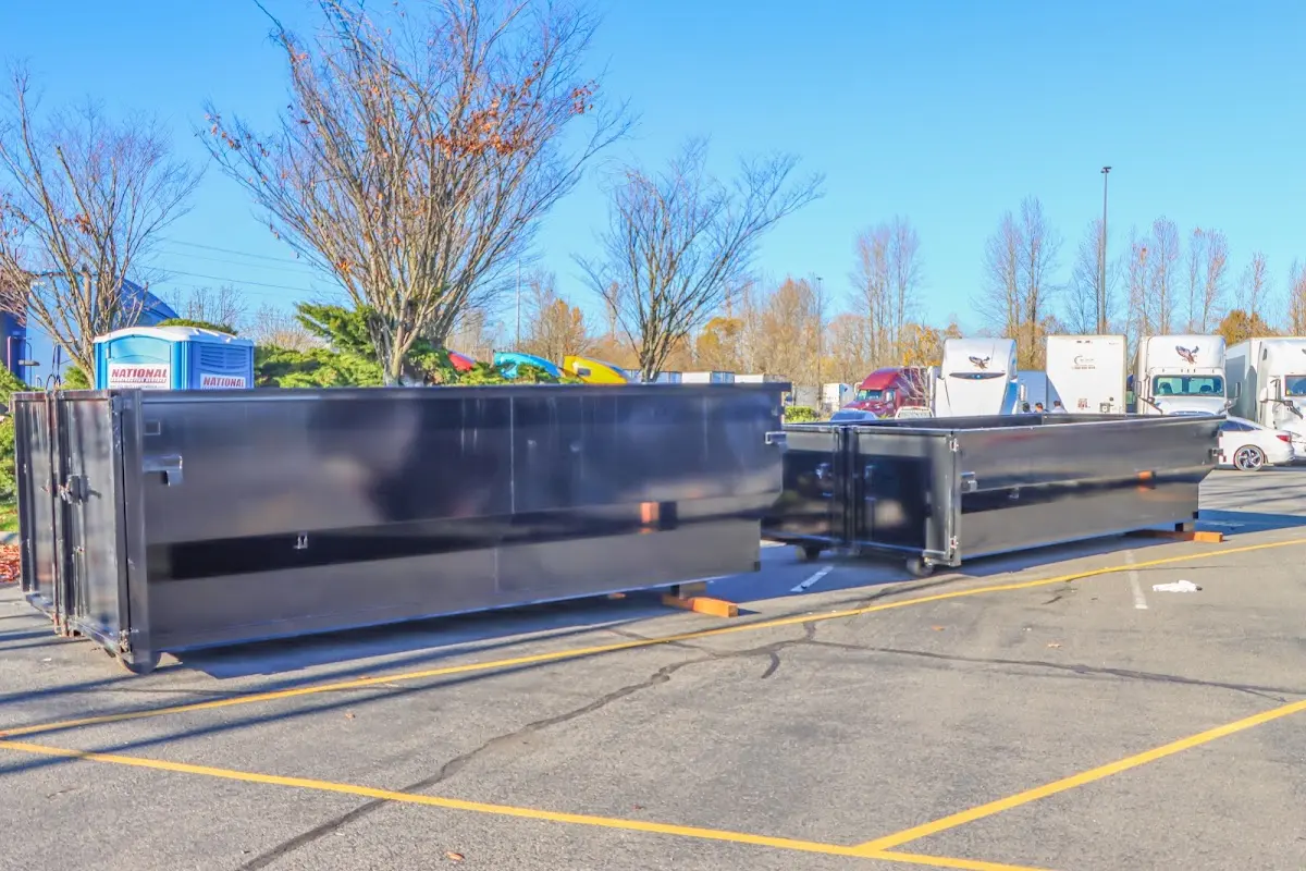 Professional dumpster rental service with roll-off container on residential driveway in Murrieta